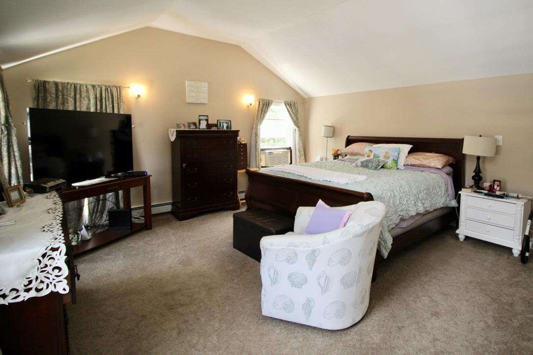 10 Lan Road Sandwich, MA 02563 - Photo 21 of 35 a spacious bedroom with a bed and a flat screen television