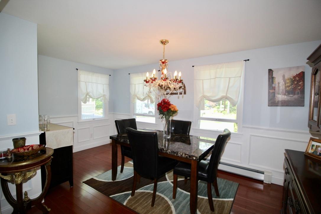 10 Lan Road Sandwich, MA 02563 - Photo 8 of 35 a dining room with furniture a chandelier and wooden floor