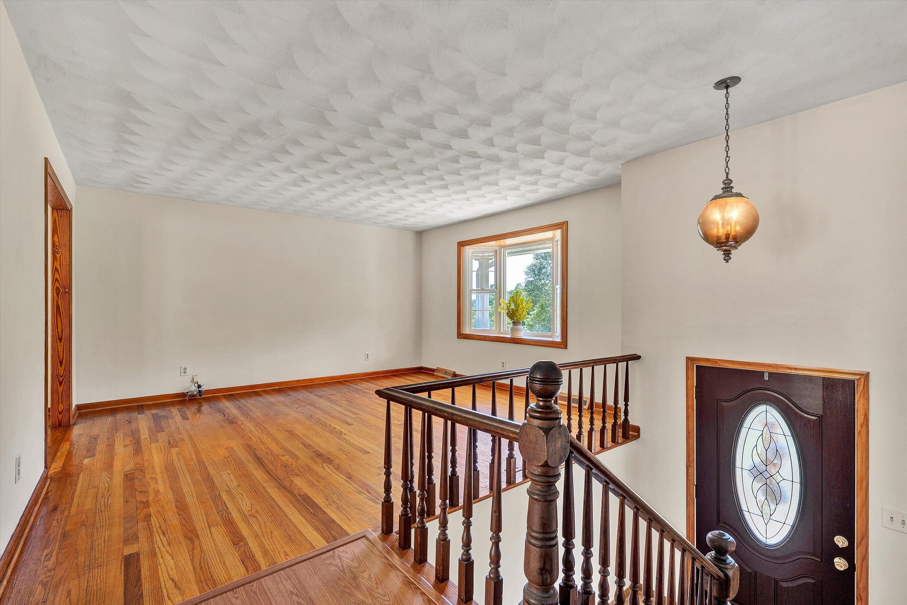 133 Kelsey Way Fincastle, VA 24090 - Photo 12 of 58 a view of a hallway with wooden floor and staircase