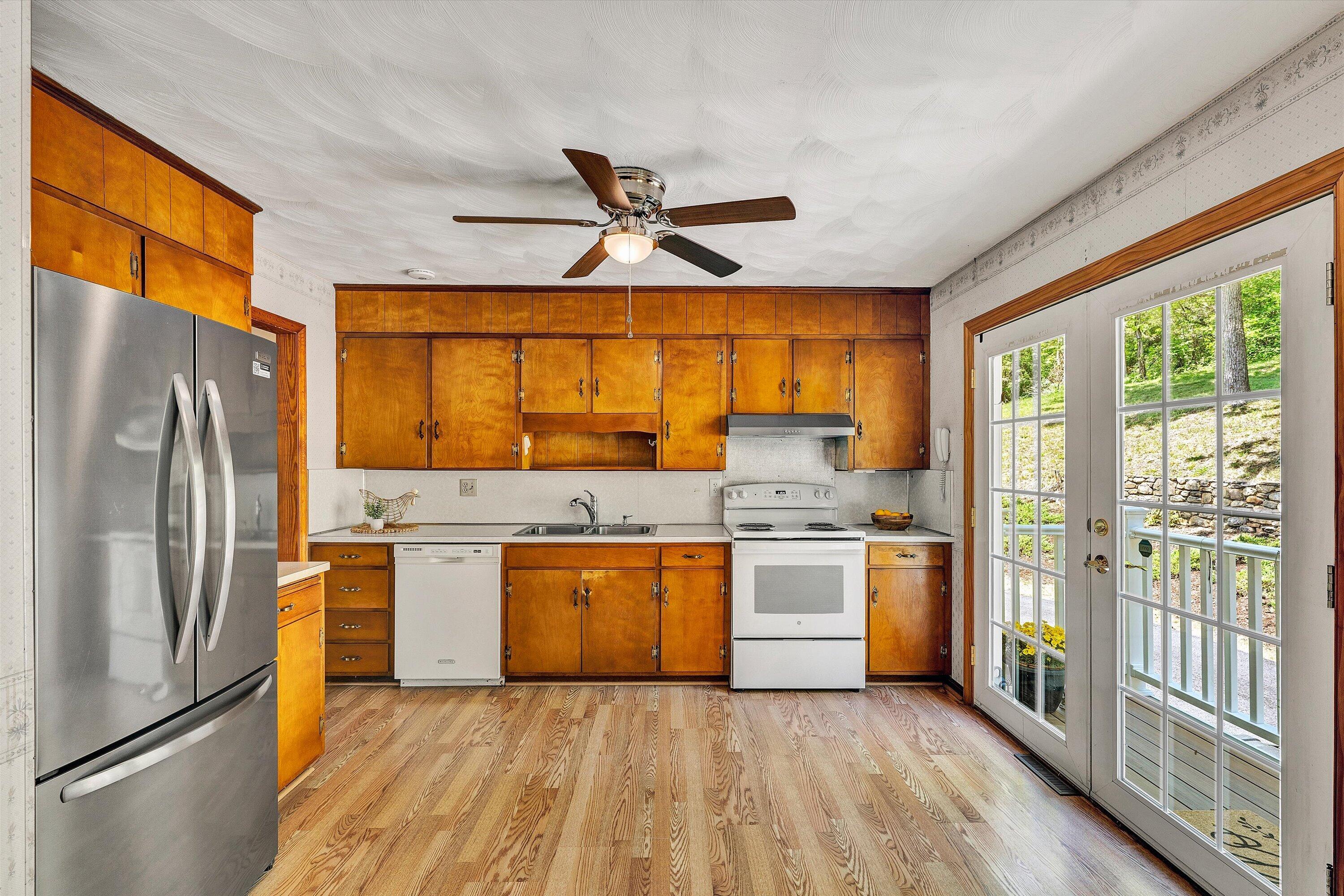 133 Kelsey Way Fincastle, VA 24090 - Photo 18 of 58 a kitchen with a refrigerator a stove top oven a sink and a large window
