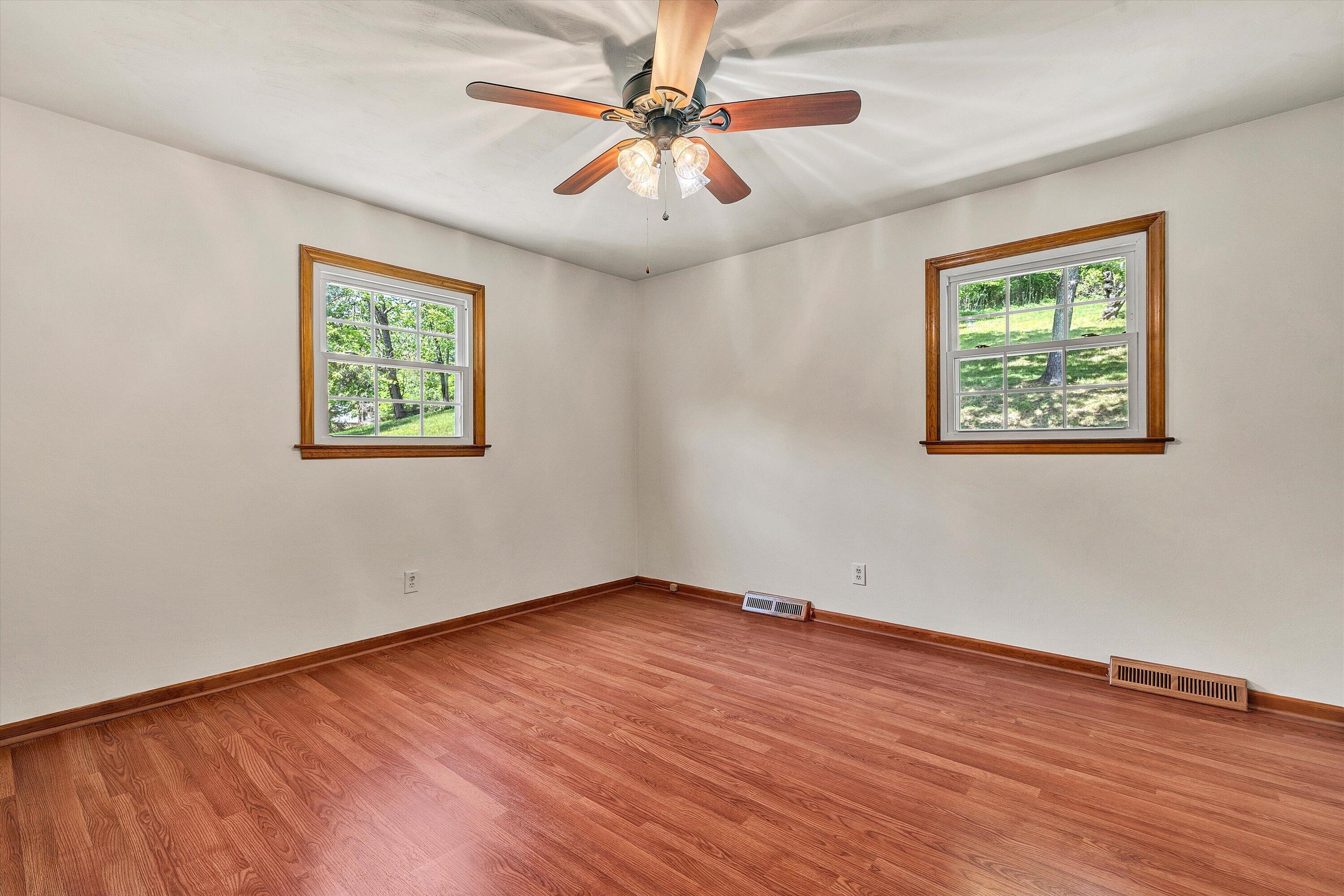 133 Kelsey Way Fincastle, VA 24090 - Photo 23 of 58 a view of an empty room with window and wooden floor