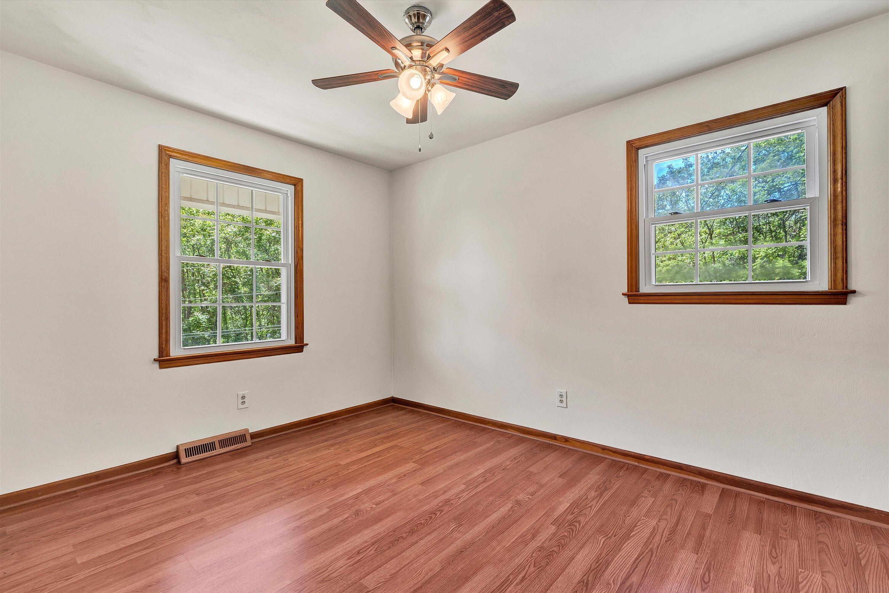 133 Kelsey Way Fincastle, VA 24090 - Photo 24 of 58 a view of an empty room with wooden floor and a window