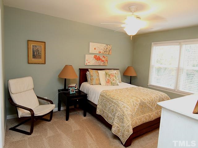 3512 Old Post Road Raleigh, NC 27612 - Photo 14 of 25 a bedroom with a bed and a chair
