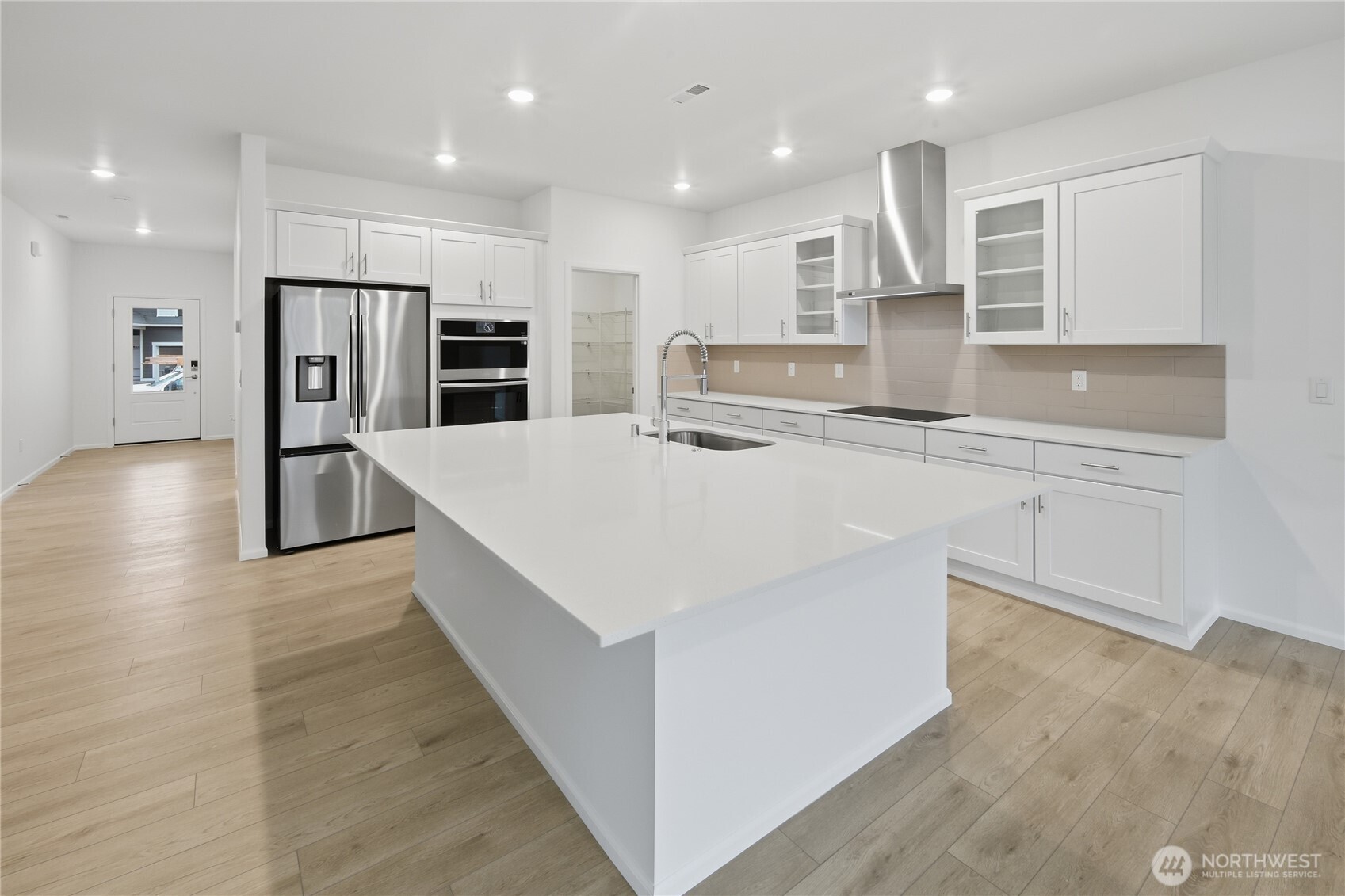 20145 135th Place Southeast Monroe, WA 98272 - Photo 2 of 19 a large kitchen with stainless steel appliances kitchen island a large counter top and a stove top oven