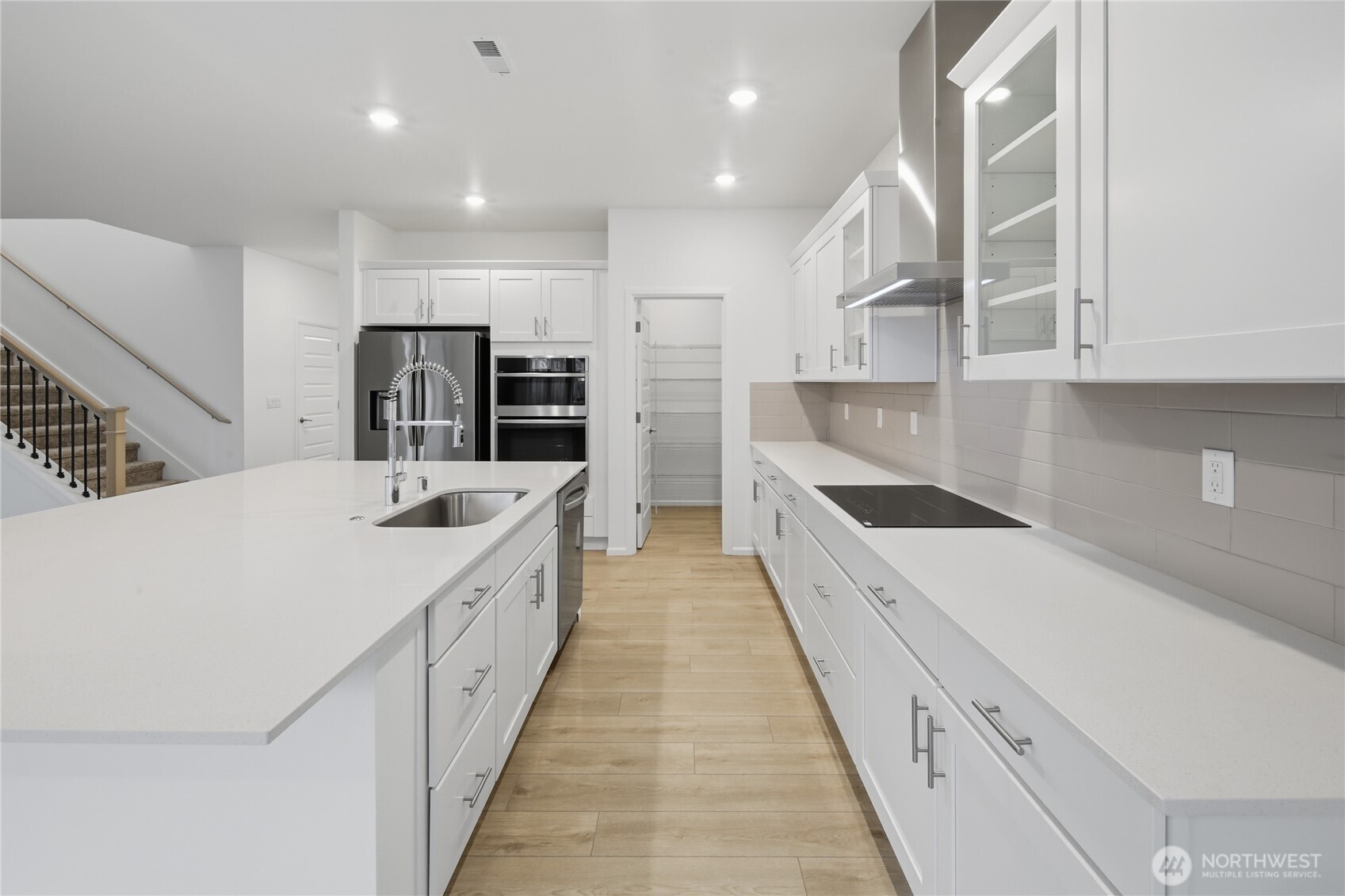 20145 135th Place Southeast Monroe, WA 98272 - Photo 3 of 19 a large white kitchen with a large window and stainless steel appliances