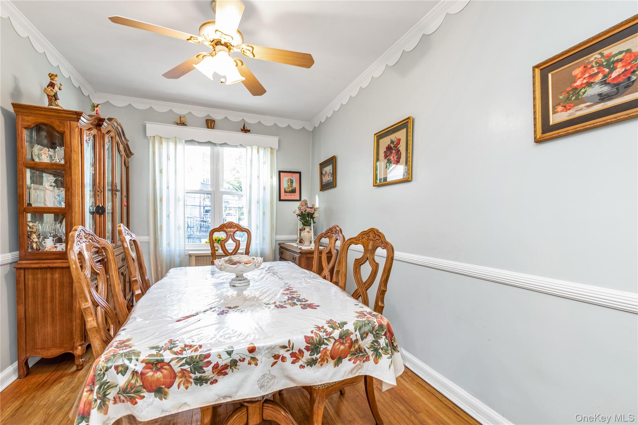 142-24 61st Road Queens, NY 11367 - Photo 7 of 18 Dining space with wood finished floors, crown molding, and ceiling fan