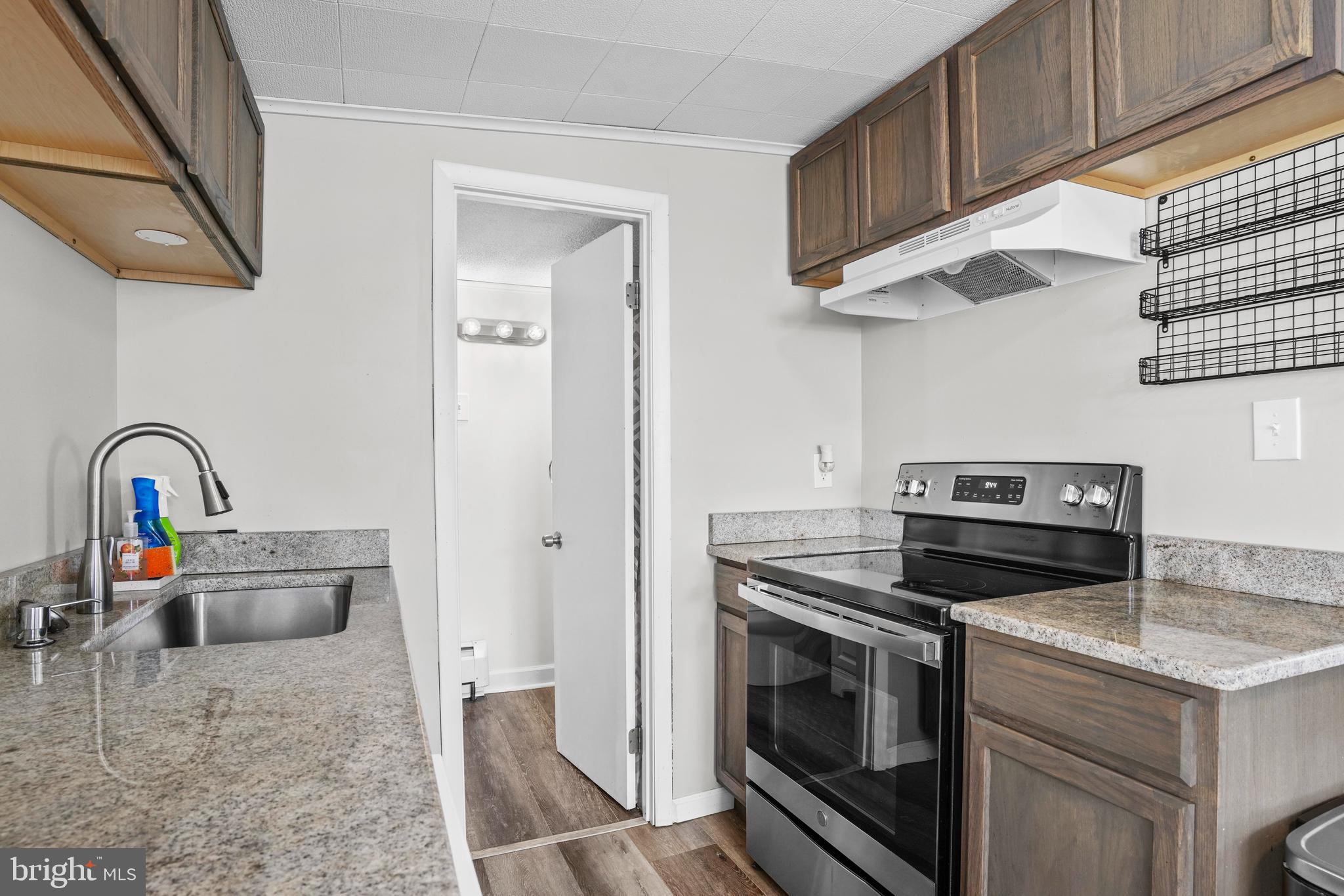 1816 Keymar Road Edgewater, MD 21037 - Photo 11 of 39 a kitchen with stainless steel appliances granite countertop a stove a sink and a microwave