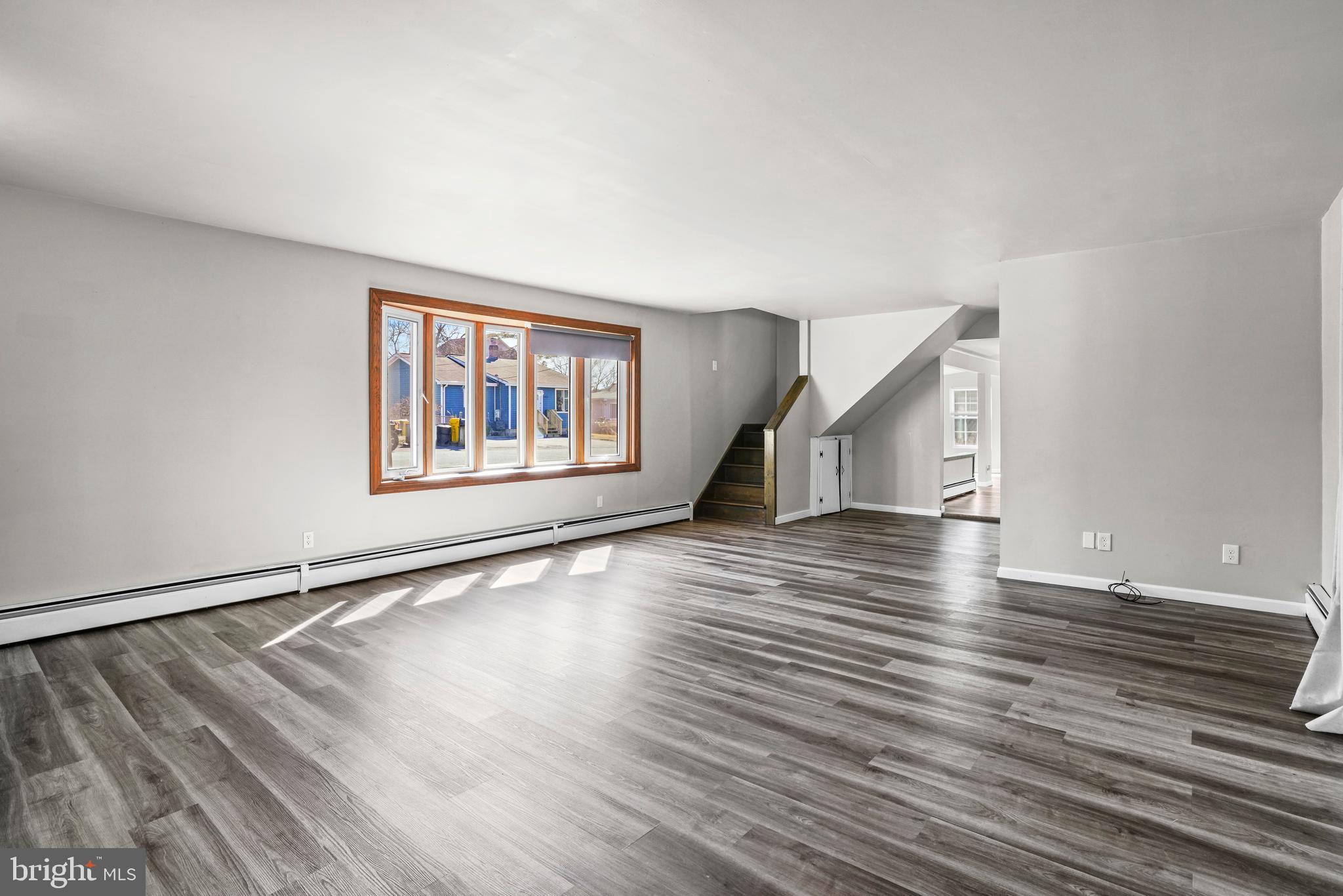 1816 Keymar Road Edgewater, MD 21037 - Photo 2 of 39 a view of an empty room with wooden floor and a window