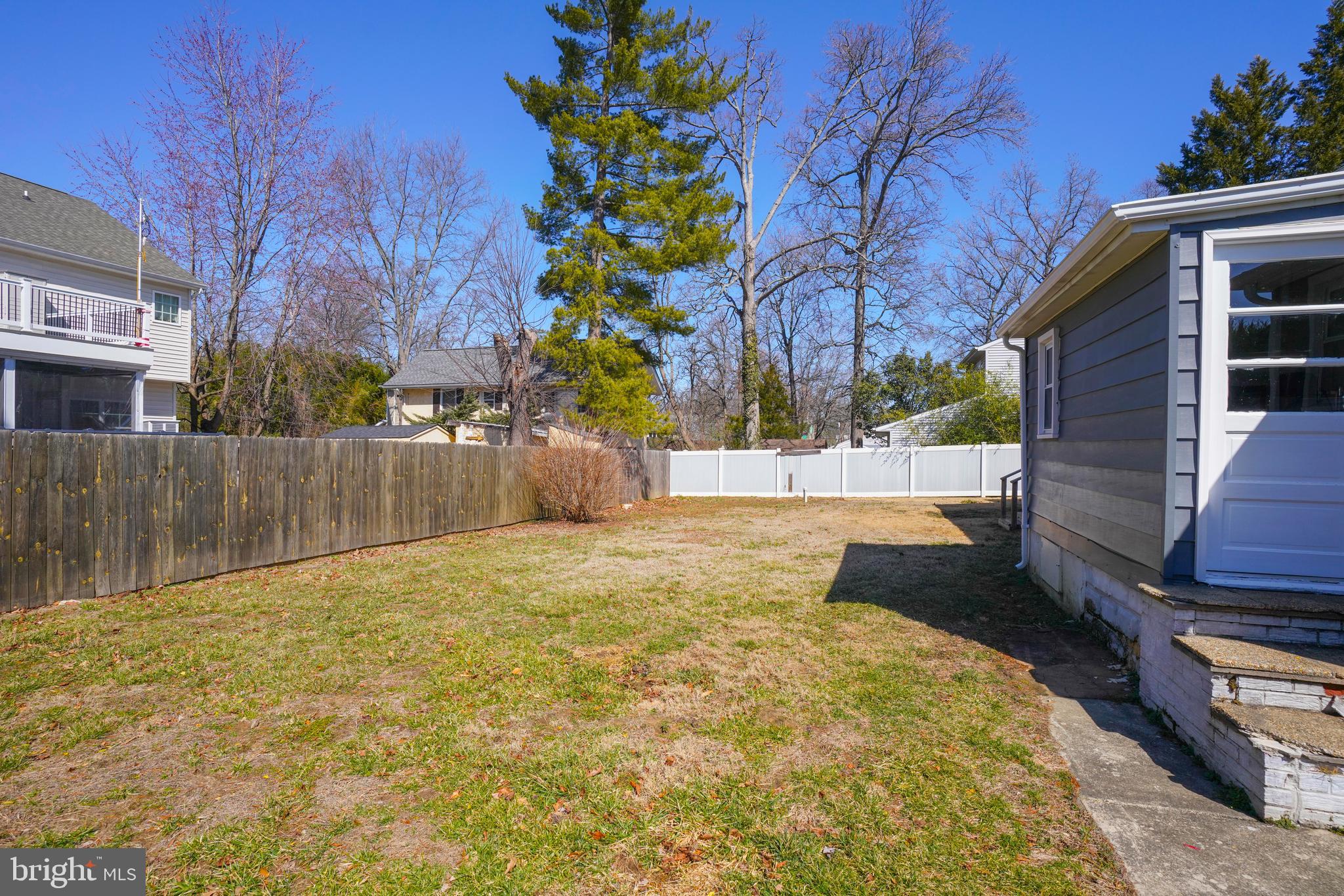 1816 Keymar Road Edgewater, MD 21037 - Photo 28 of 39 a view of backyard with wooden fence and large trees