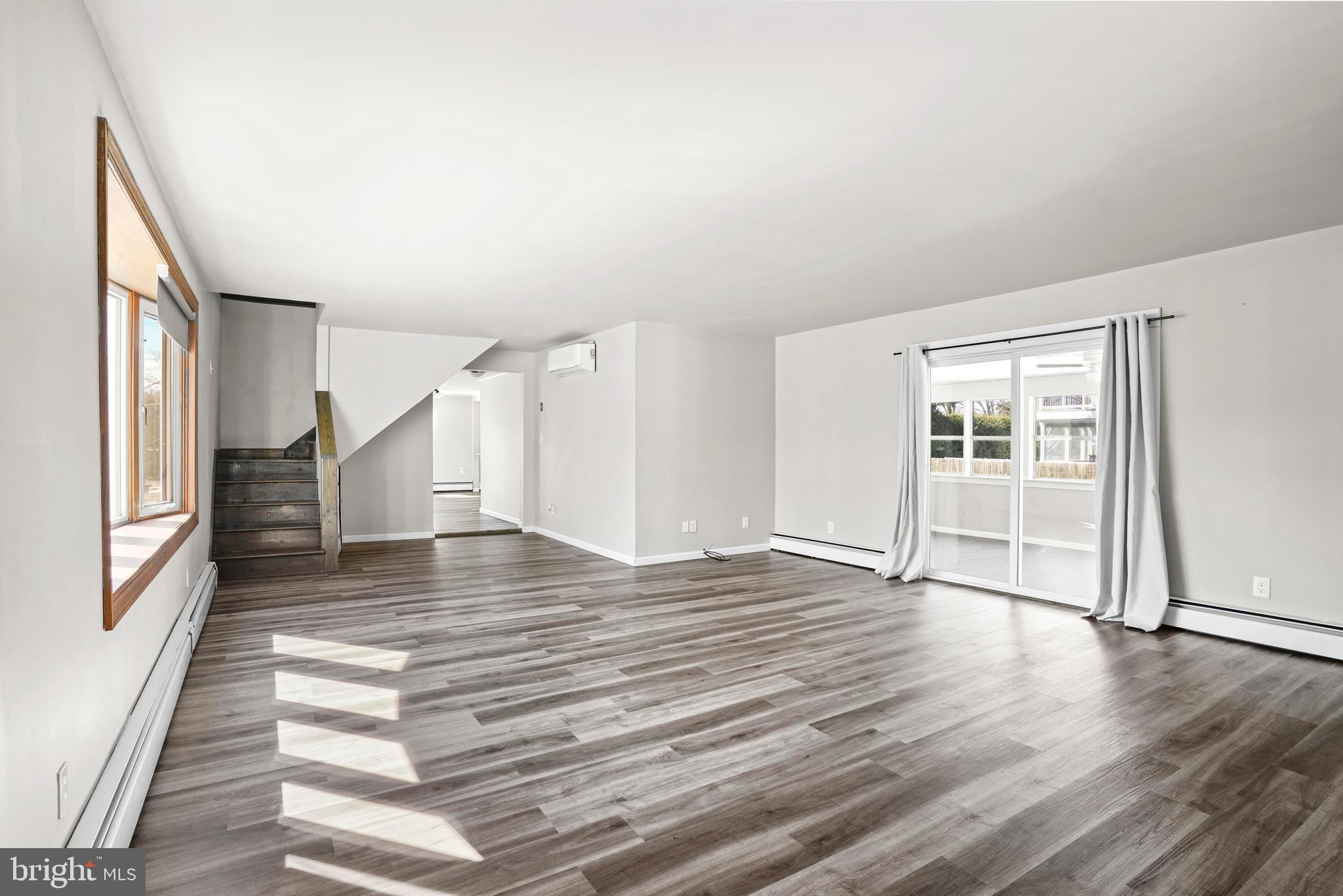 1816 Keymar Road Edgewater, MD 21037 - Photo 4 of 39 a view of an empty room with wooden floor and a window