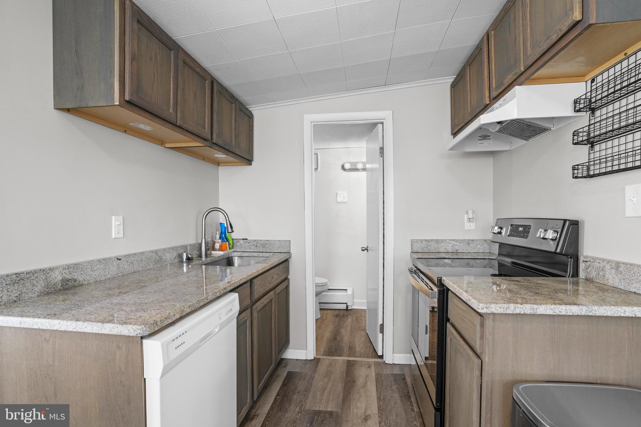 1816 Keymar Road Edgewater, MD 21037 - Photo 10 of 39 a kitchen with stainless steel appliances granite countertop a sink stove and cabinets