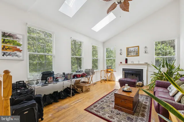 a living room with furniture fireplace and a large window