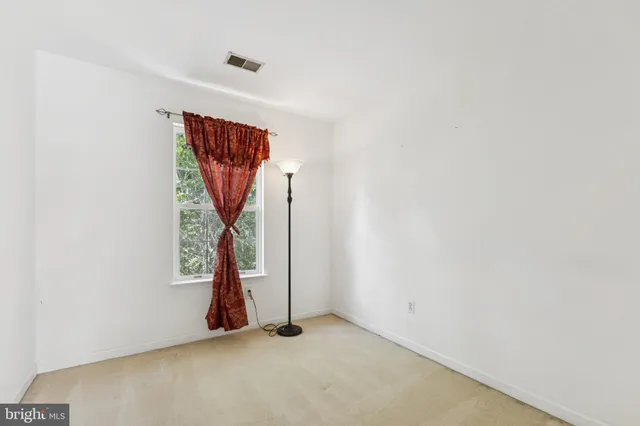 a view of an empty room with stairs