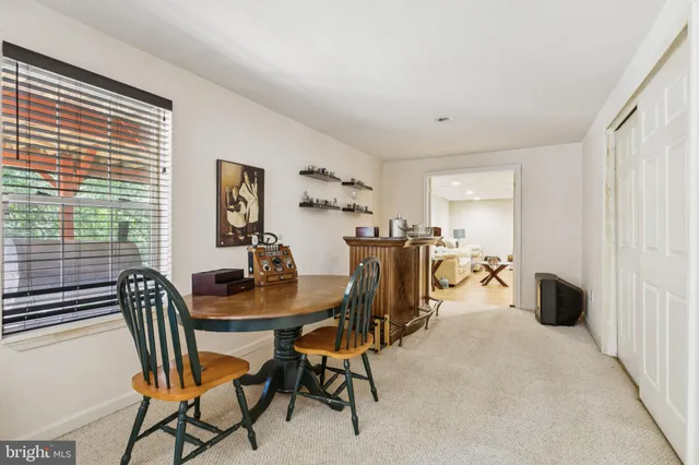 a dining room with furniture and a window