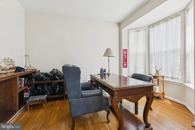 a view of a workspace with furniture and a window