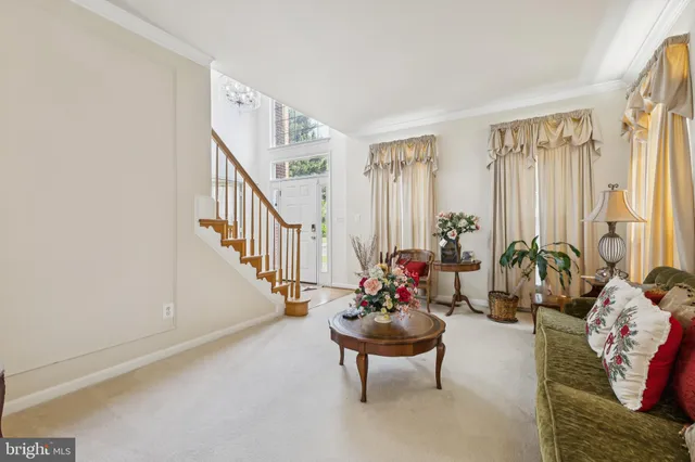 a living room with furniture and flowers