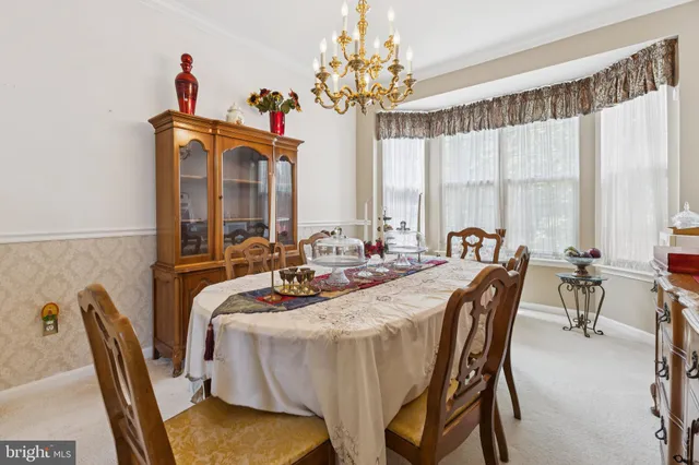 a view of a dining room with furniture and a chandelier