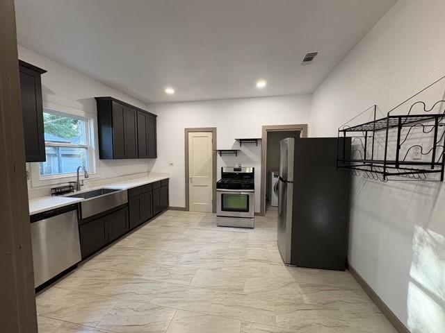 4876 East Williams Spring Road Fort Worth, TX 76135 - Photo 3 of 20 a large kitchen with granite countertop a refrigerator and a sink