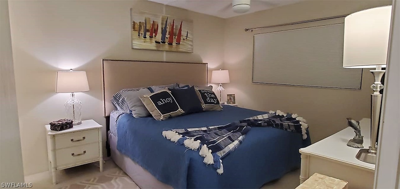 400 Lenell Road, Unit 207 Fort Myers Beach, FL 33931 - Photo 11 of 16 a bed sitting in a bedroom next to a window