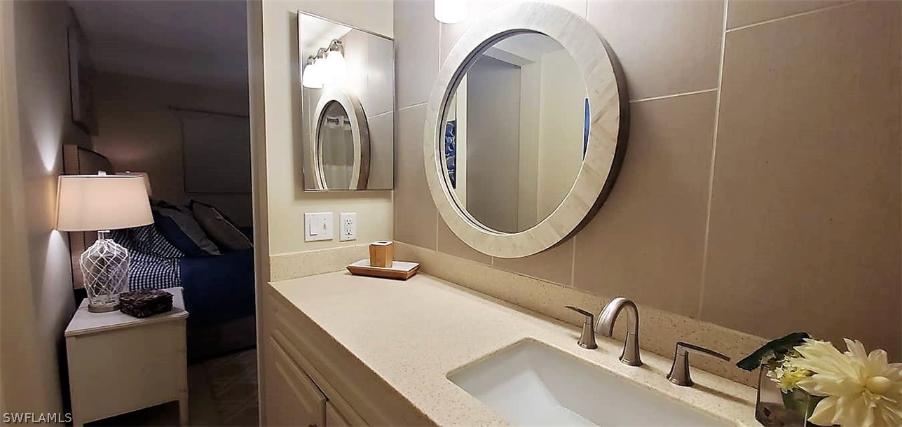 400 Lenell Road, Unit 207 Fort Myers Beach, FL 33931 - Photo 12 of 16 a bathroom with a sink and a mirror