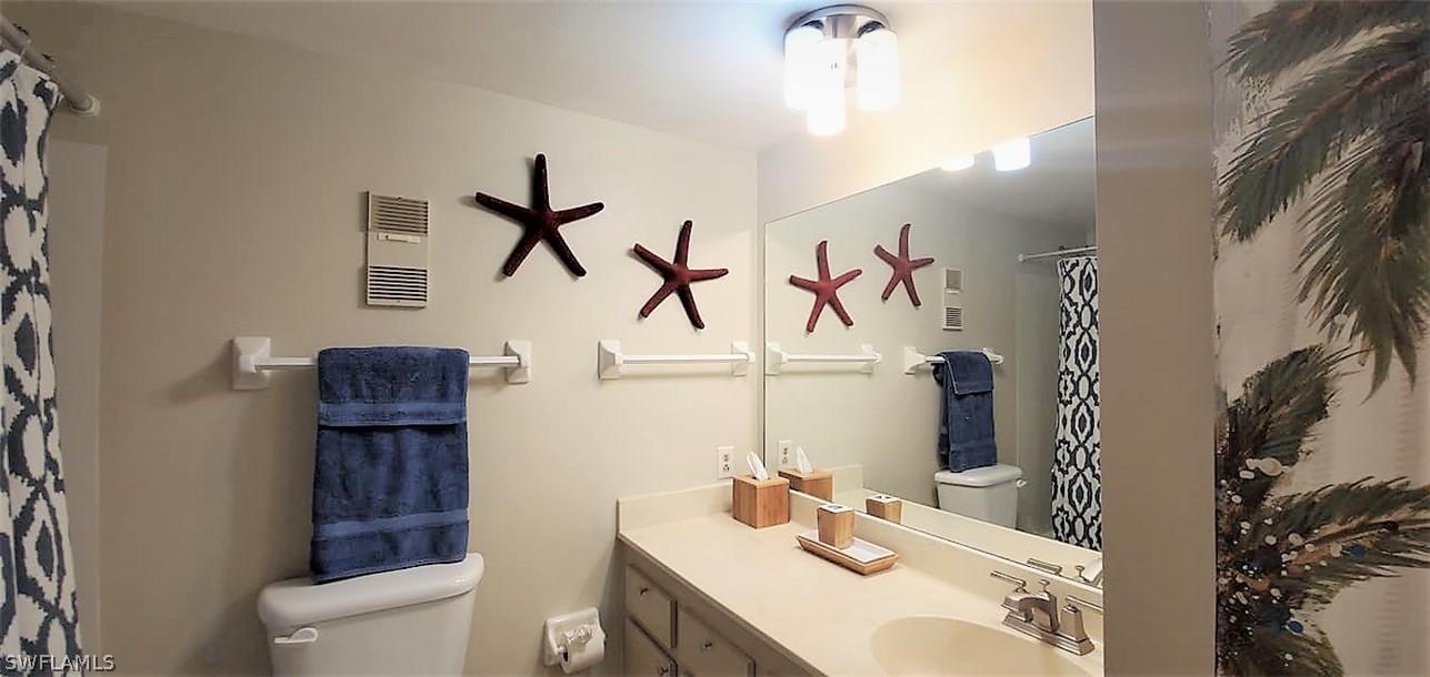 400 Lenell Road, Unit 207 Fort Myers Beach, FL 33931 - Photo 15 of 16 a bathroom with a sink a toilet and mirror