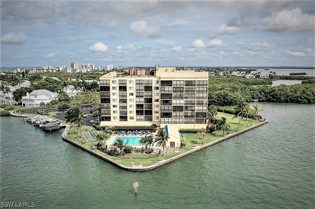 400 Lenell Road, Unit 207 Fort Myers Beach, FL 33931 - Photo 16 of 16 a view of a lake with a building in the background
