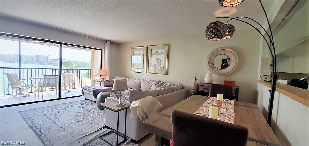 400 Lenell Road, Unit 207 Fort Myers Beach, FL 33931 - Photo 3 of 16 a living room with furniture and a large window