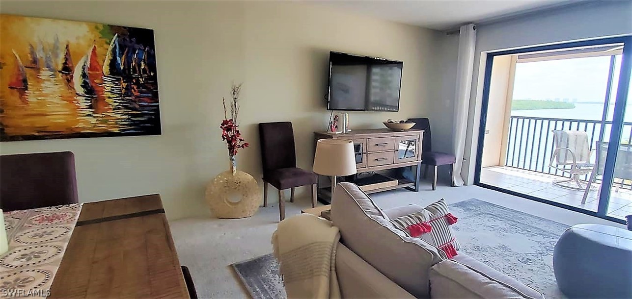 400 Lenell Road, Unit 207 Fort Myers Beach, FL 33931 - Photo 5 of 16 a living room with furniture and a flat screen tv