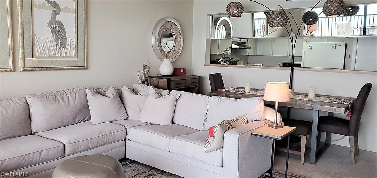 400 Lenell Road, Unit 207 Fort Myers Beach, FL 33931 - Photo 6 of 16 a living room with furniture and a chair