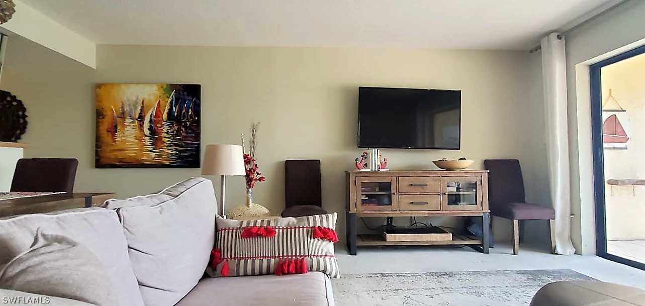 400 Lenell Road, Unit 207 Fort Myers Beach, FL 33931 - Photo 7 of 16 a bedroom with furniture and a flat screen tv