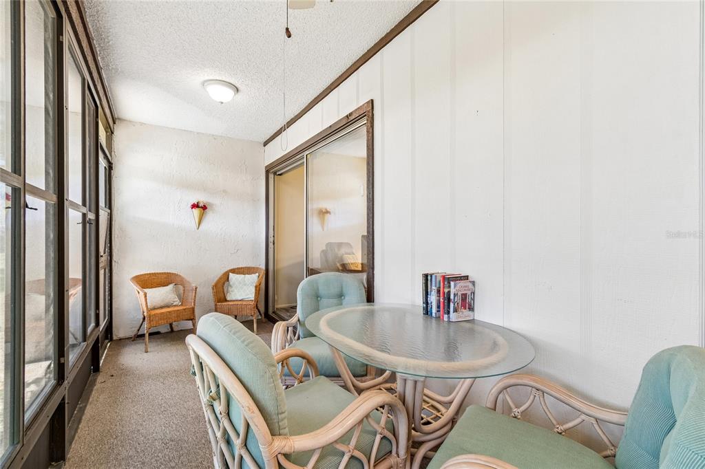 11340 Carriage Hill Drive, Unit 4 Port Richey, FL 34668 - Photo 18 of 36 a table and chairs in a balcony