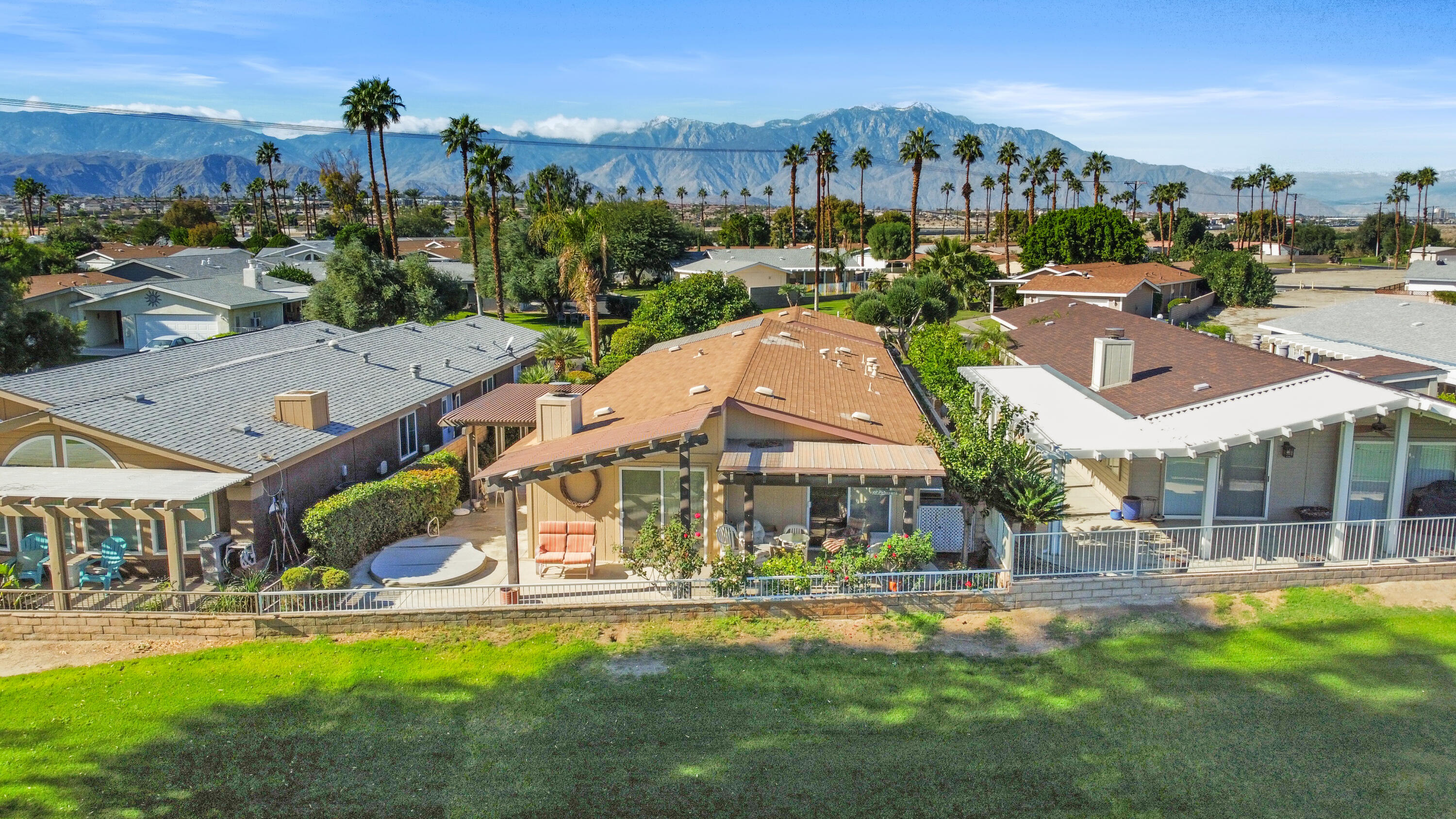 an aerial view of a house with swimming pool garden and lake view