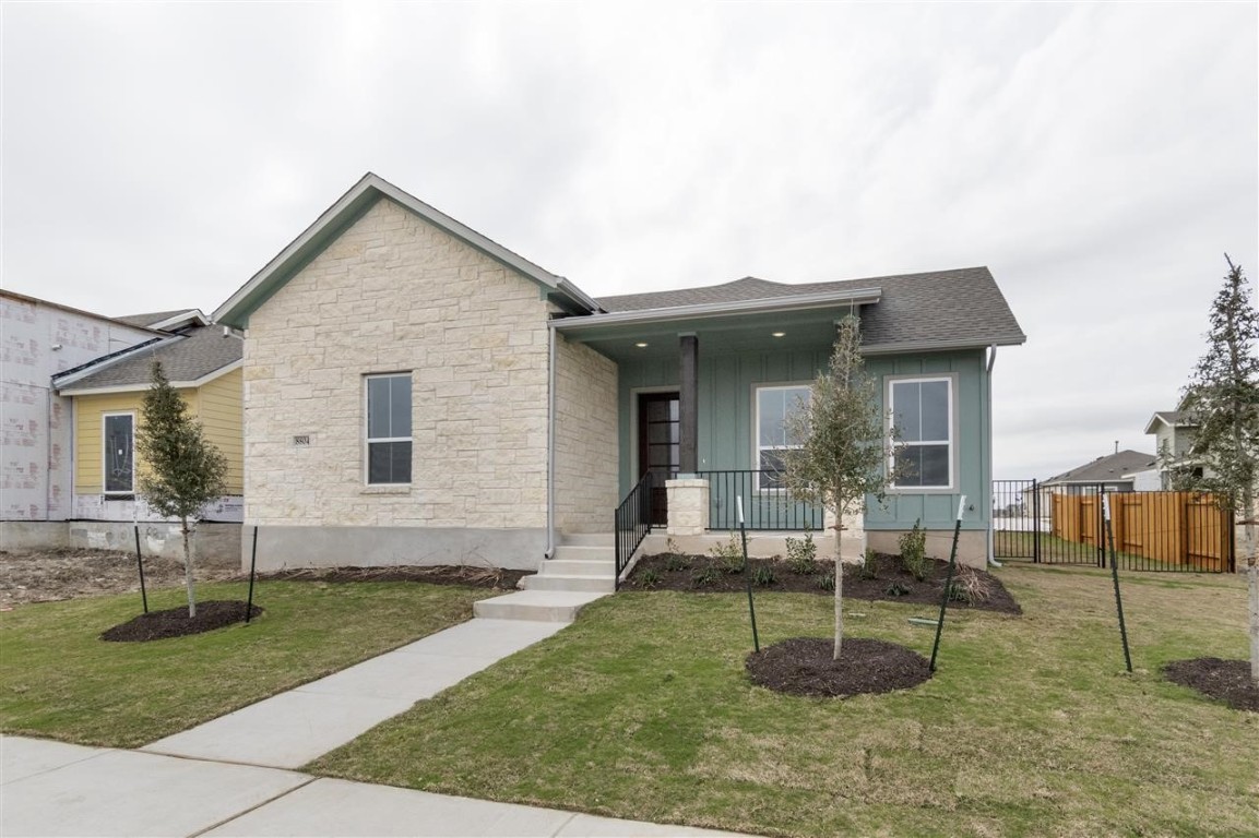 a view of house with a backyard