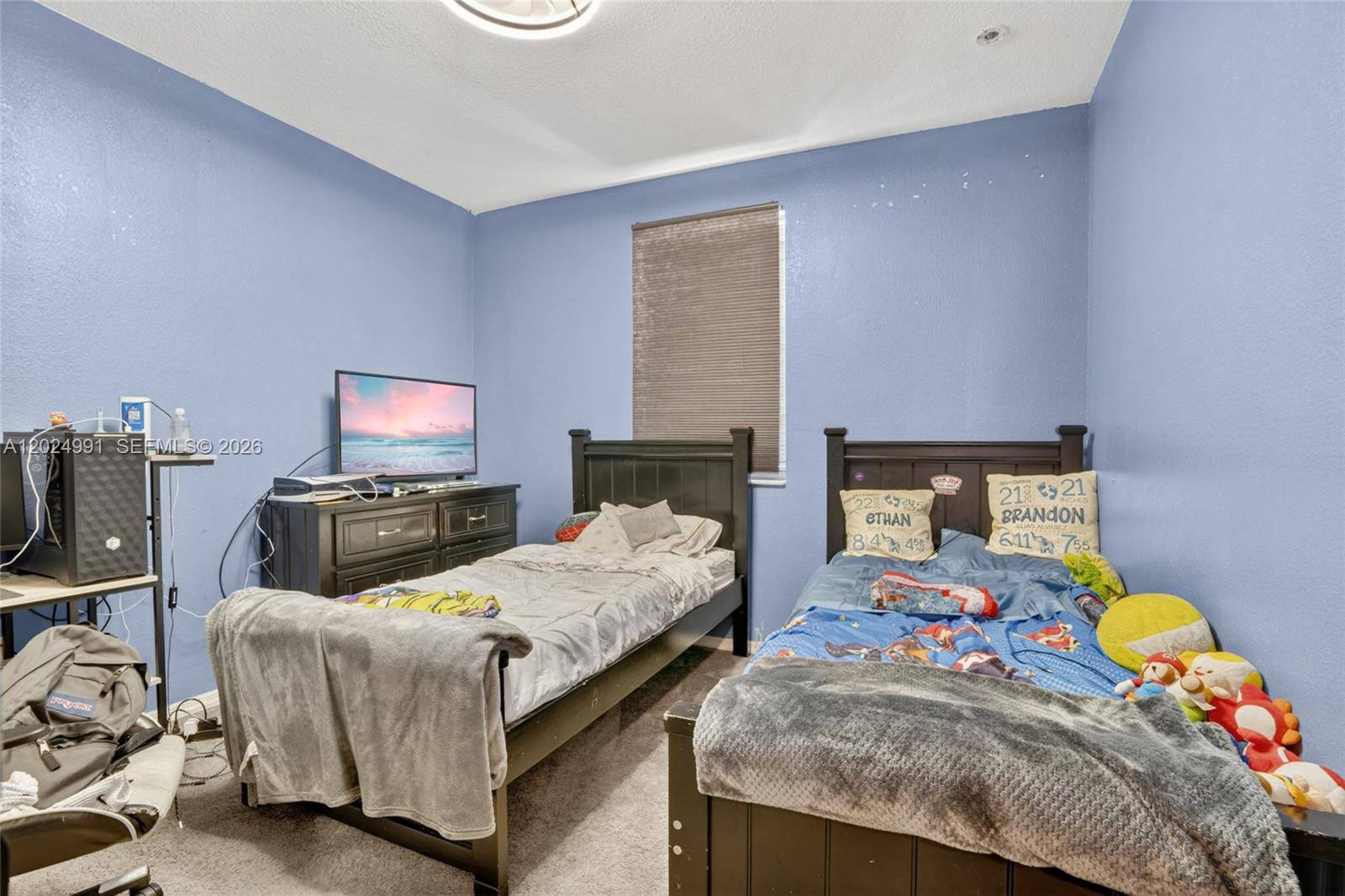 16651 Southwest 79th Terrace Miami, FL 33193 - Photo 17 of 34 a bedroom with two beds and a flat screen tv