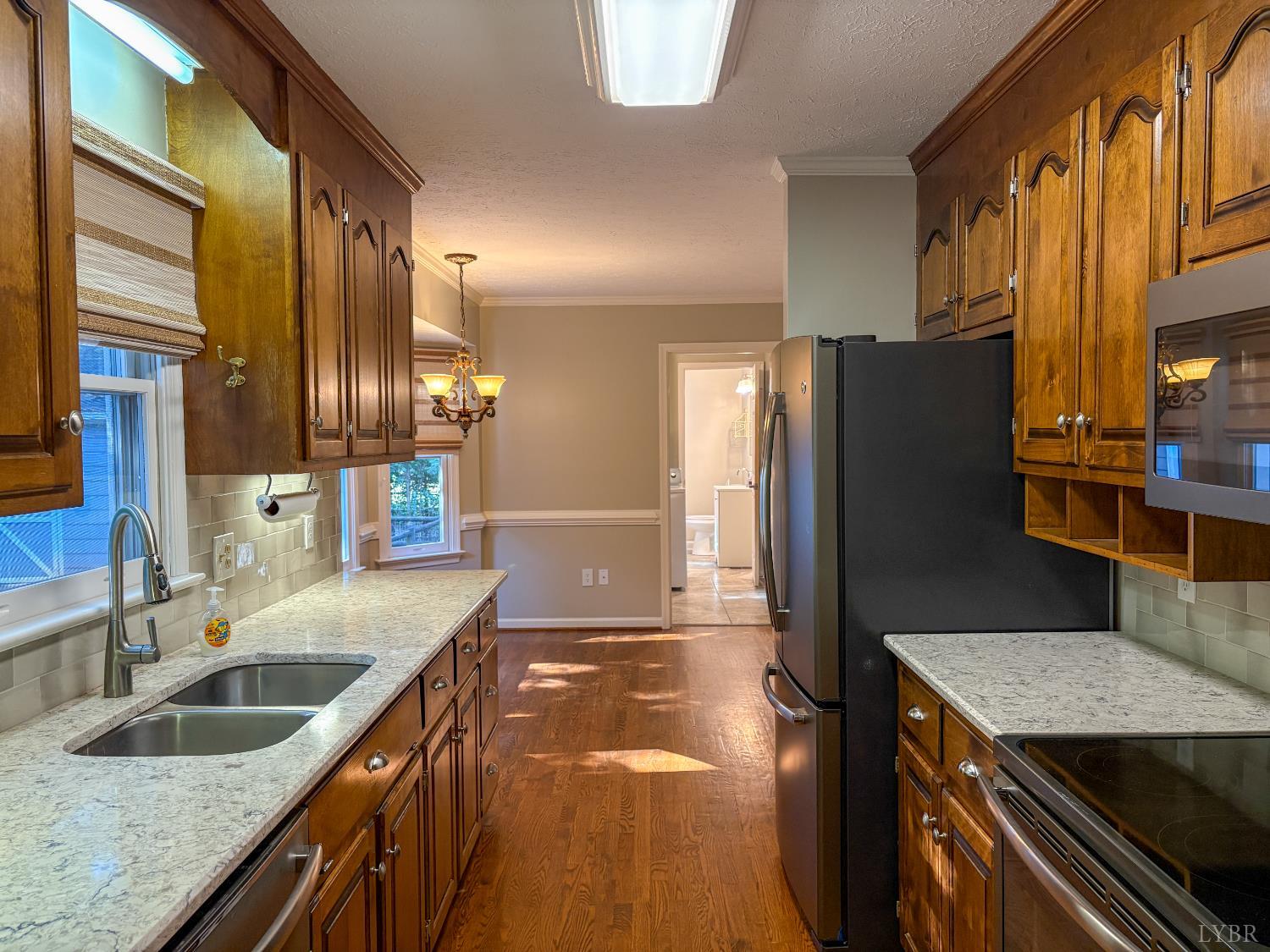 202 Hounds Run Forest, VA 24551 - Photo 11 of 38 a kitchen with stainless steel appliances granite countertop a sink a stove and a refrigerator