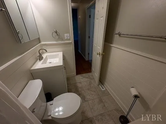 a view of a room with rack on the wall and a window