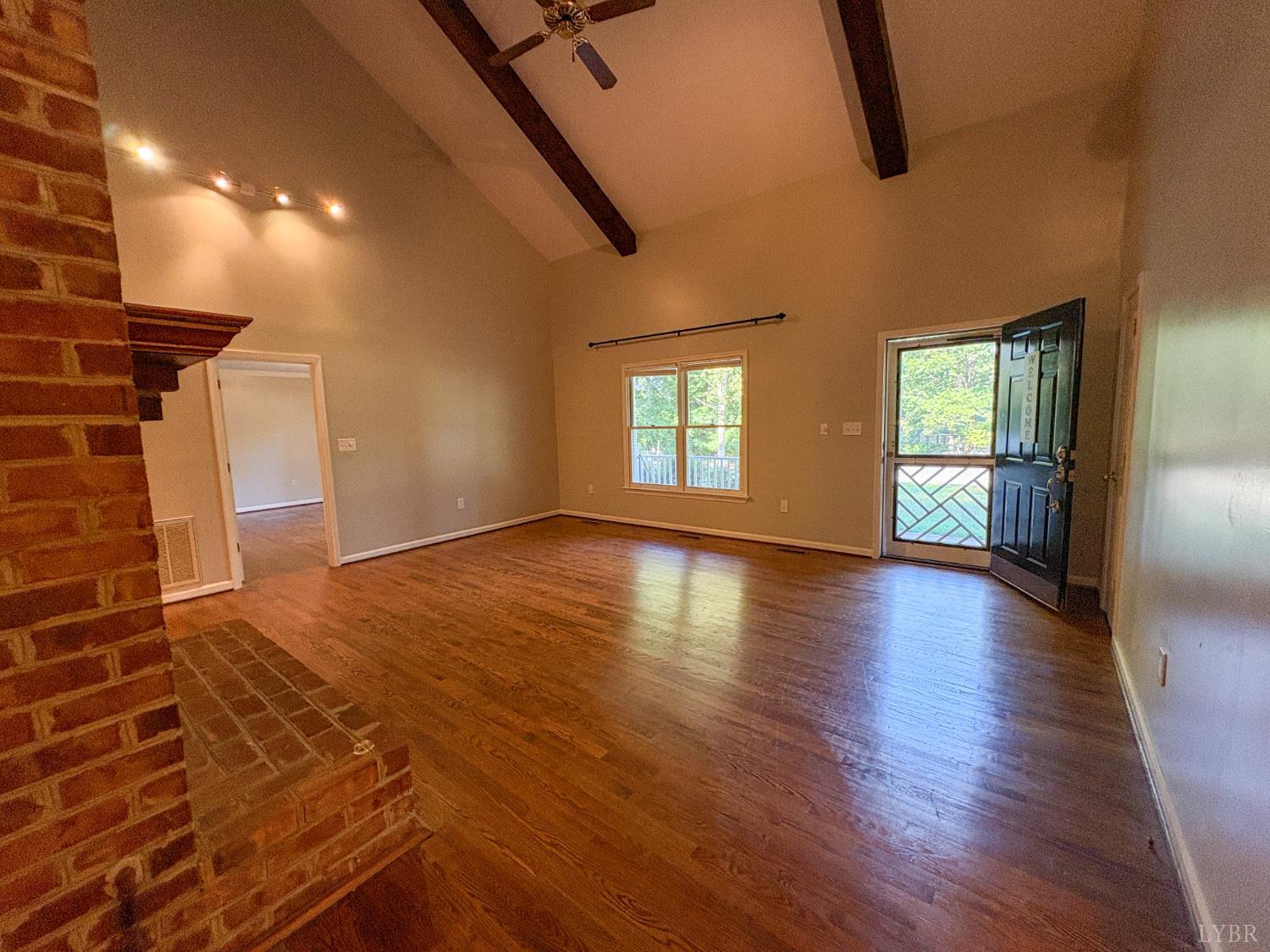 202 Hounds Run Forest, VA 24551 - Photo 7 of 38 a view of an empty room with wooden floor and a window