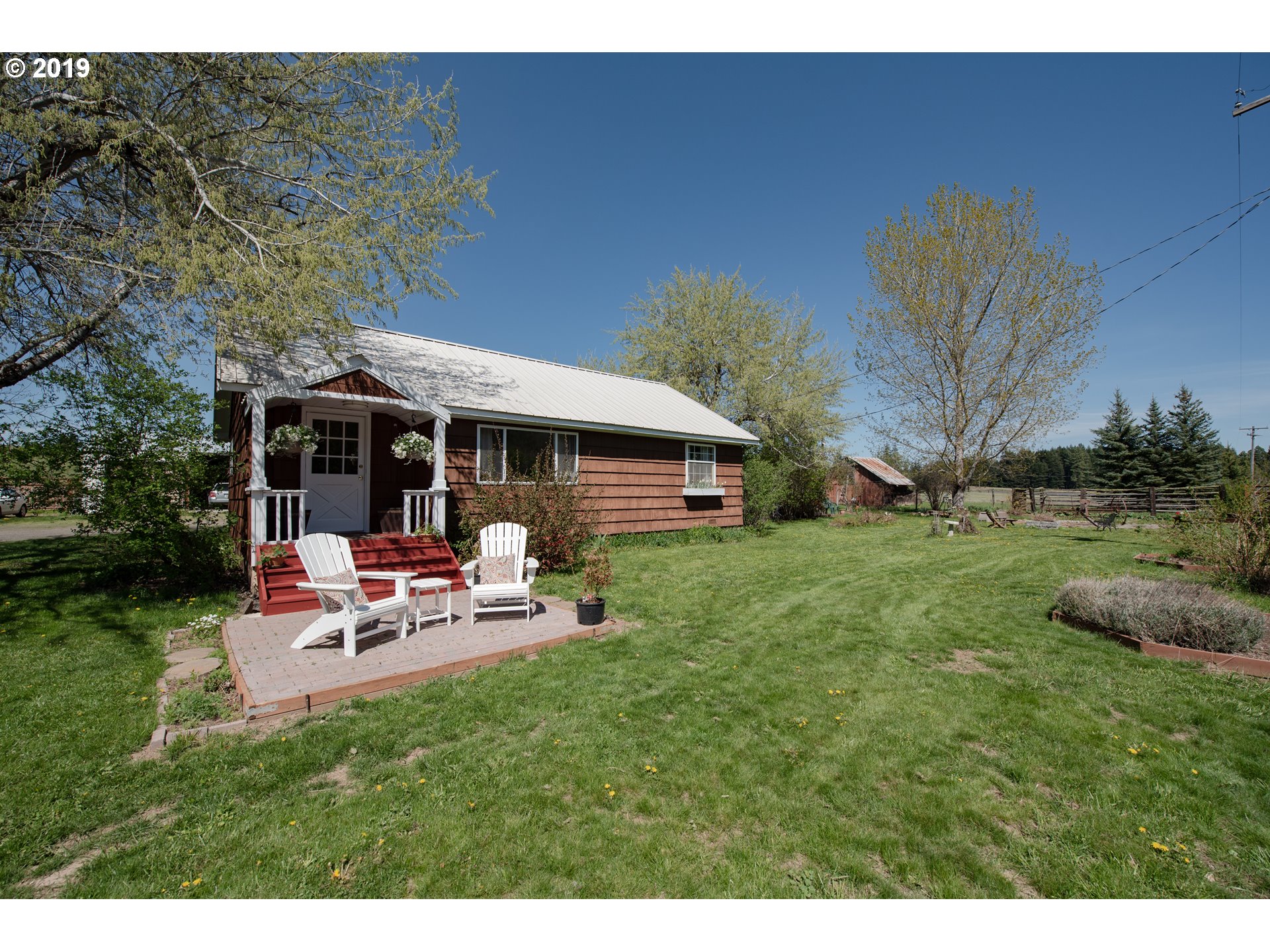 581 Snowden Road White Salmon, WA 98672 - Photo 2 of 27 a view of a house with a backyard patio and garden