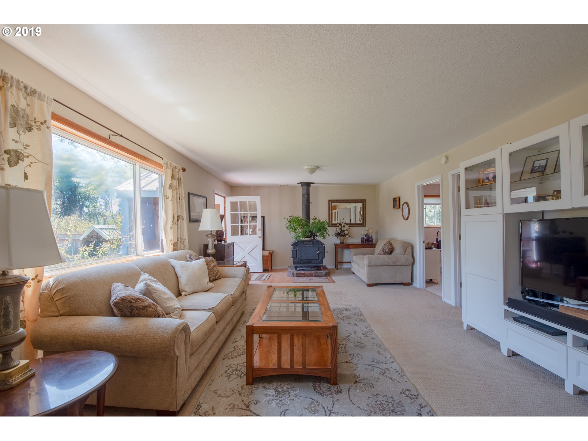 581 Snowden Road White Salmon, WA 98672 - Photo 6 of 27 a living room with furniture a flat screen tv and a fireplace
