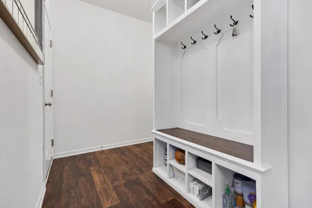a view of an empty room with wooden floor and cabinet