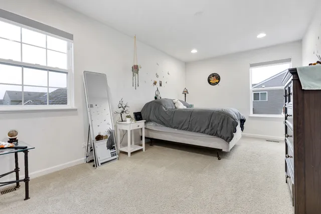 a spacious bedroom with a bed and a window
