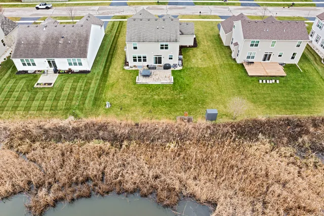 an aerial view of residential houses with outdoor space and parking