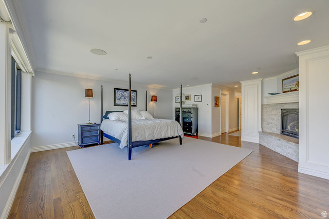 9699 Bypass Road, Unit 5 Alta, UT 84092 - Photo 43 of 54 Spacious interior featuring hardwood flooring, a gas fireplace with a stone hearth and surround, recessed lighting, crown molding, and large windows