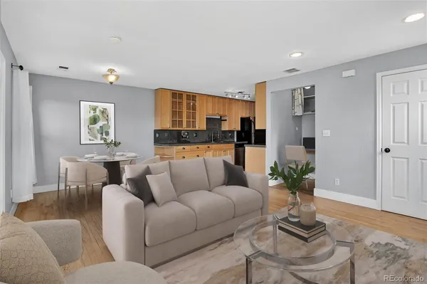 a living room with furniture and a potted plant