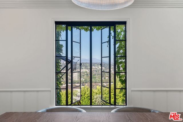 a kitchen with stainless steel appliances a sink a stove and cabinets
