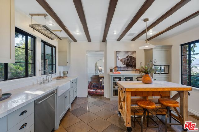 a living room with furniture a fireplace and a dining table with wooden floor