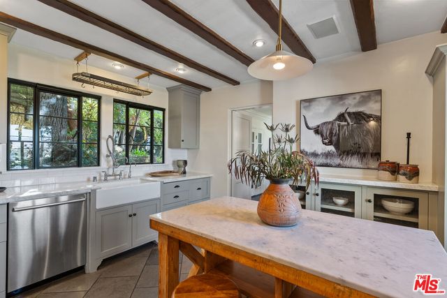 a work room with furniture and large windows