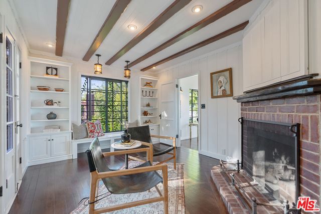 a view of a hallway with a livingroom and a couch