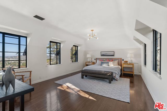 a bedroom with two beds and a window