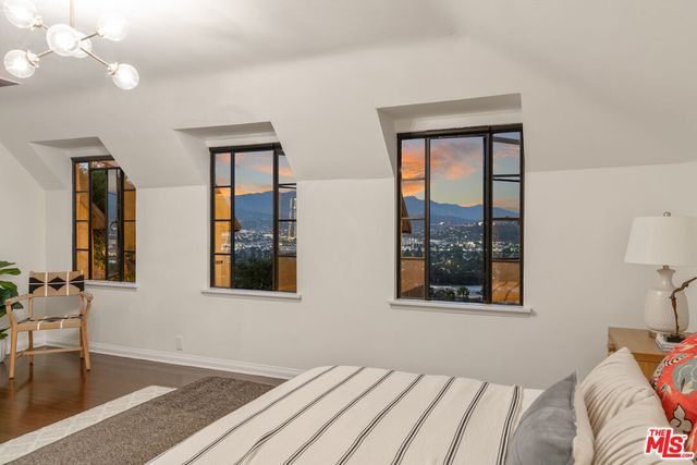 a bathroom with a sink a chandelier and a mirror